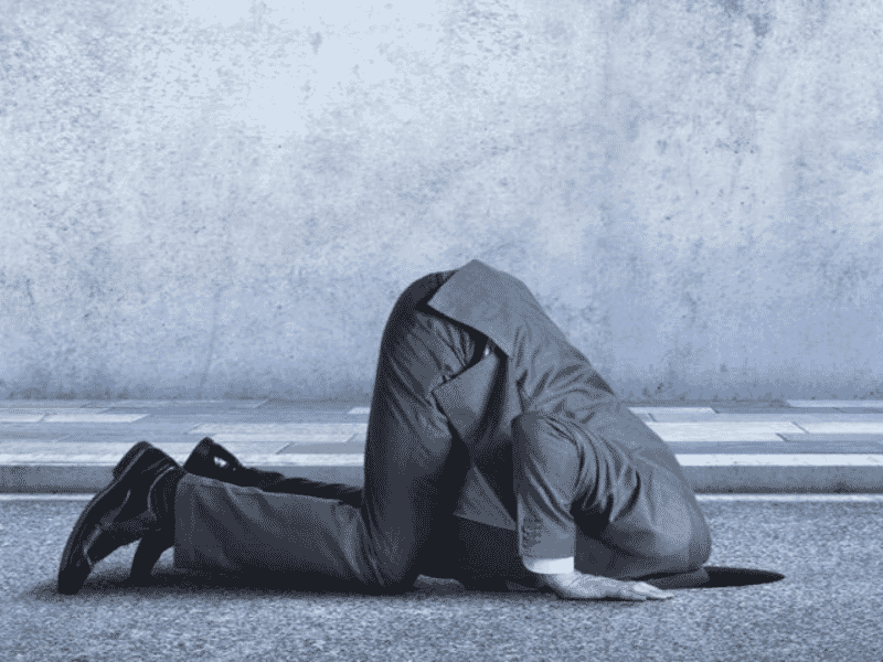 rick maurer - stage one in the dark – business person with head buried in the ground, representing denial or lack of awareness during change