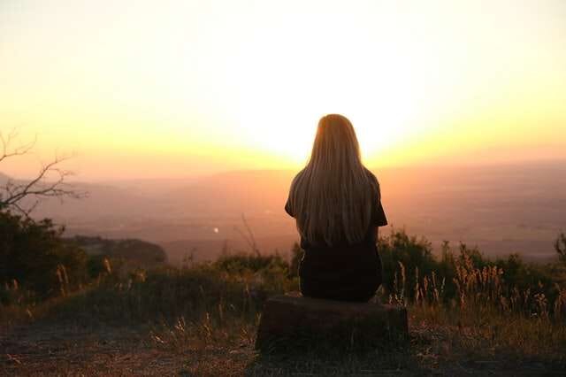woman-sitting-thinking-looking-at-sunset