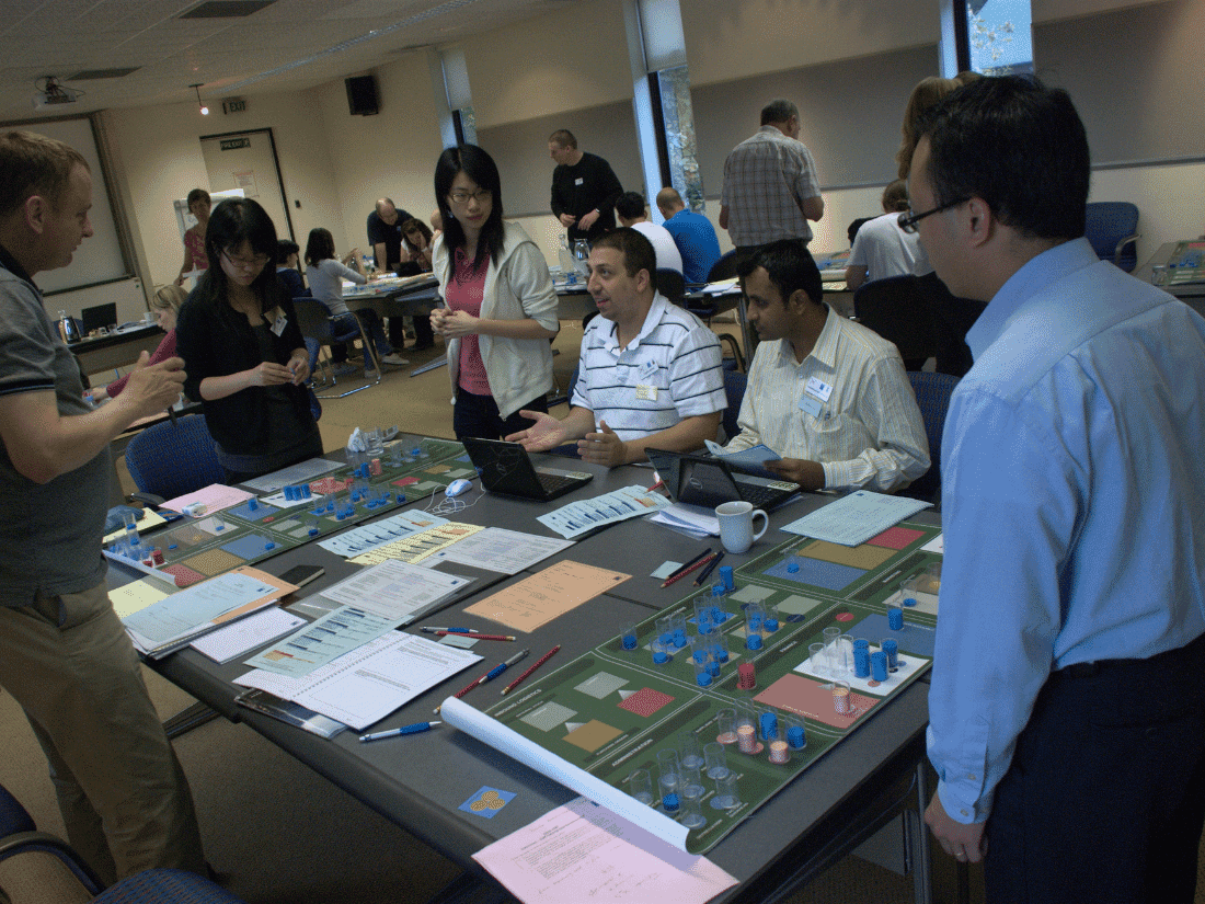 a photograph taken of senior managers engaging in a commercial leadership simulation exercise